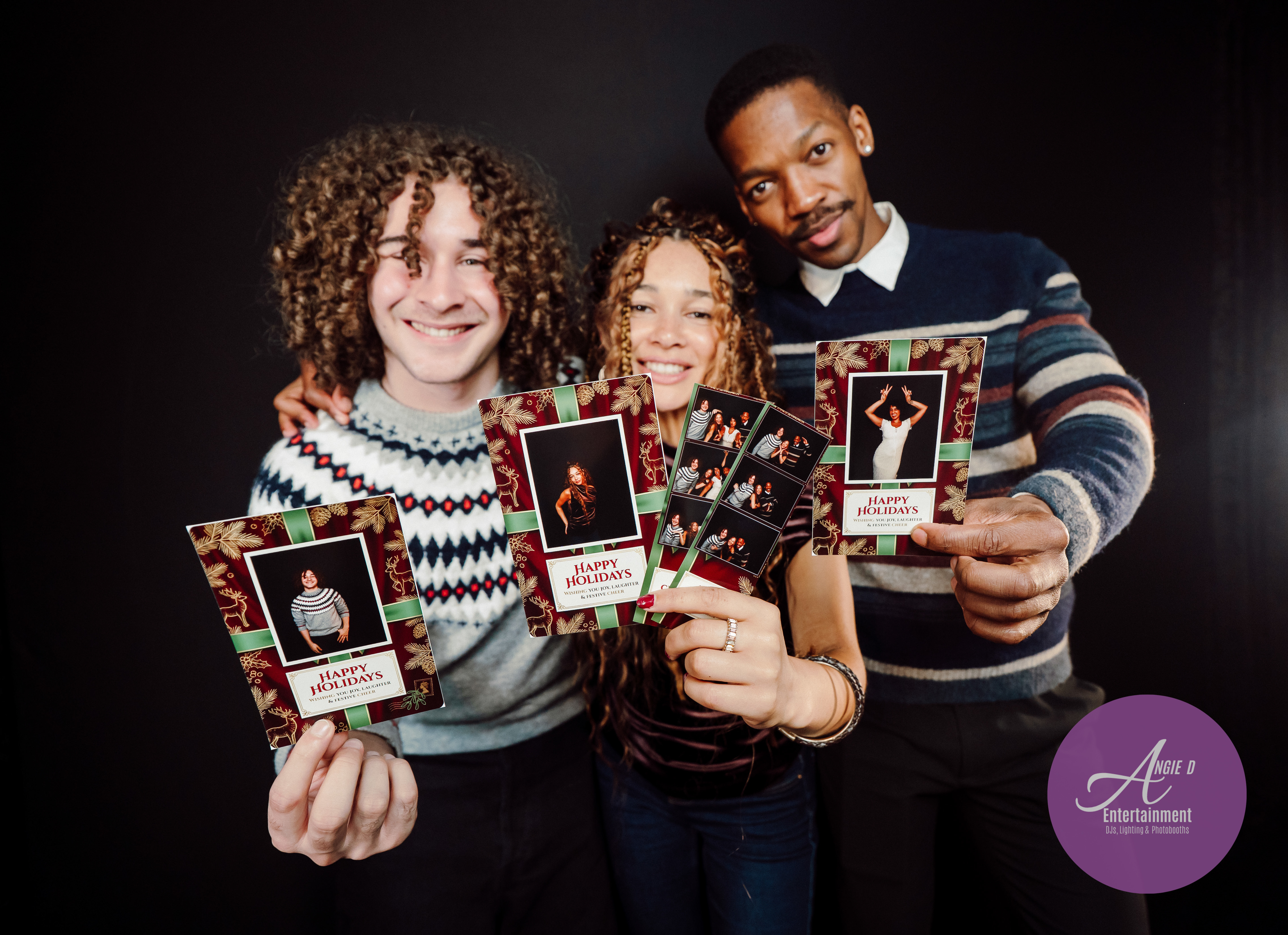 Guests holding festive holiday photo booth prints