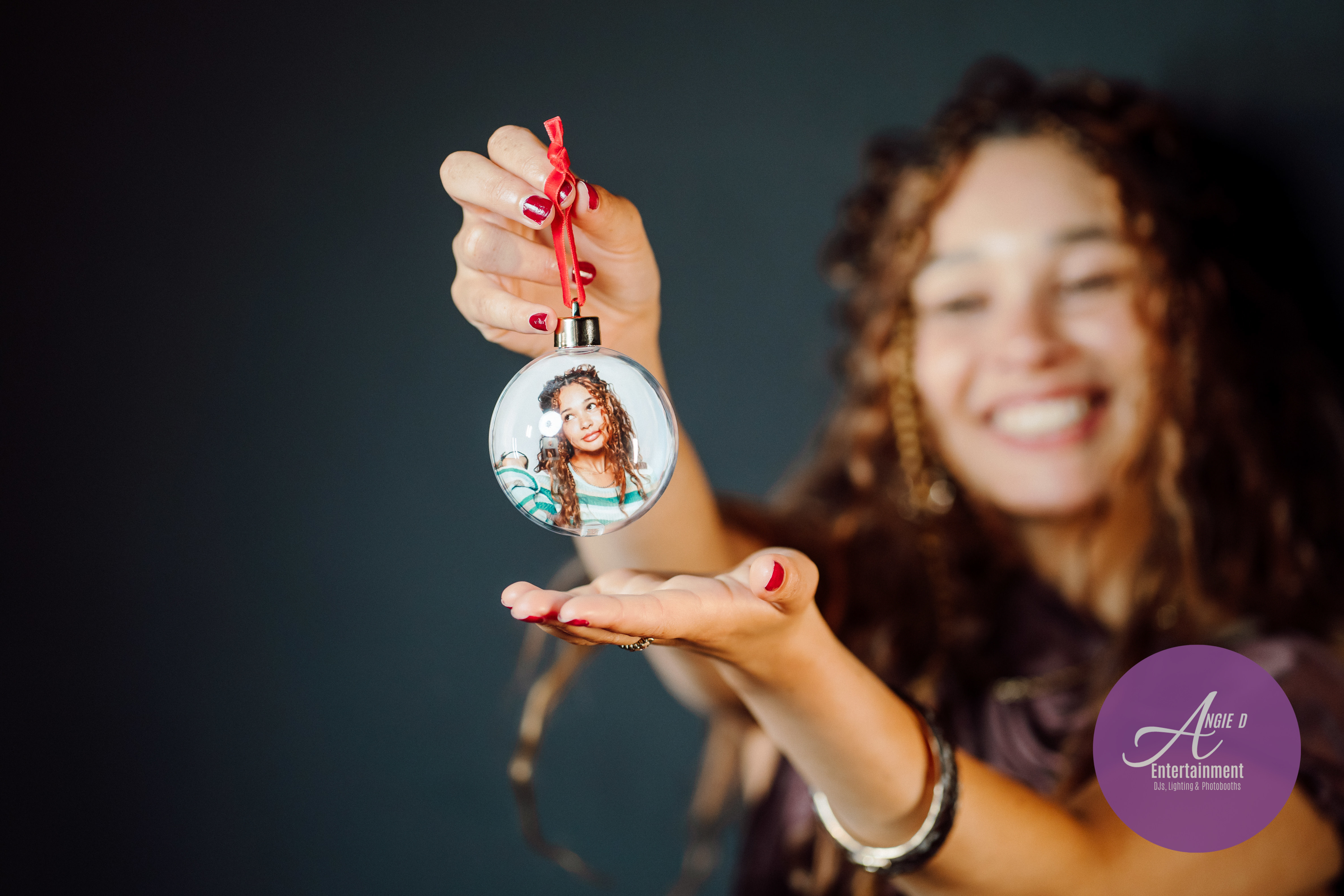 Guest holding a personalized holiday bauble photo